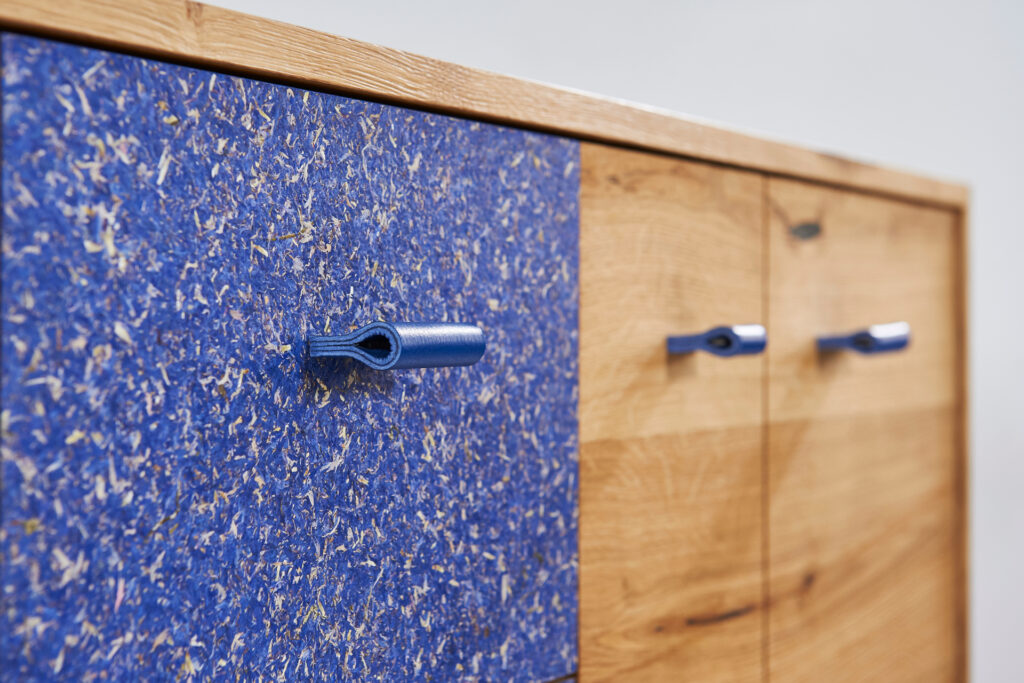 Nahaufnahme von blauen Schubladengriffen an einem Holzschrank